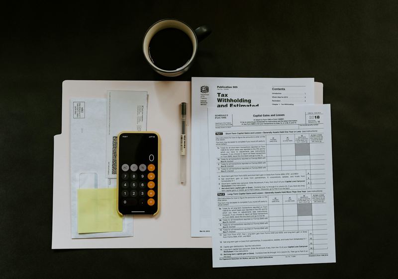 Calculator on an office desk with paperwork